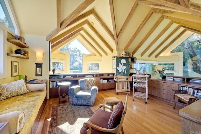 interior space with high vaulted ceiling, light hardwood / wood-style flooring, and beamed ceiling