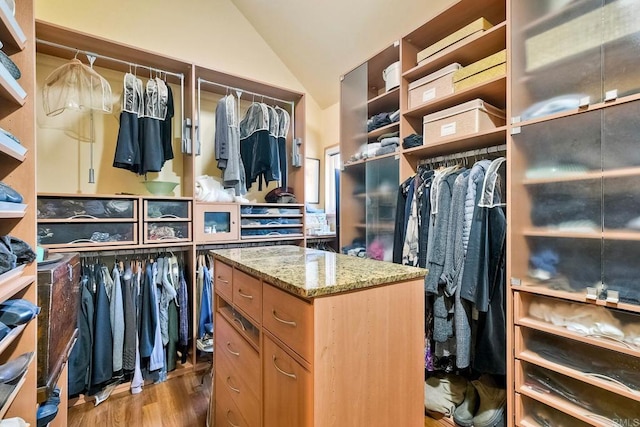 spacious closet featuring hardwood / wood-style floors and vaulted ceiling