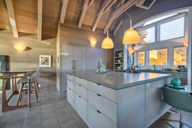 kitchen featuring wooden ceiling, hanging light fixtures, high vaulted ceiling, beam ceiling, and white cabinets