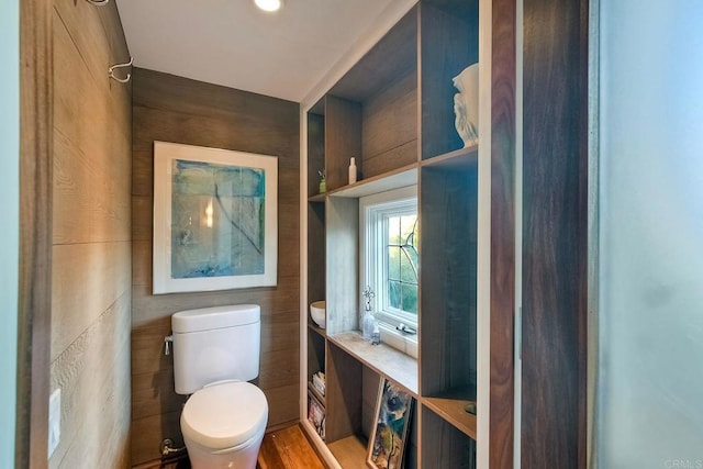 bathroom with toilet and hardwood / wood-style flooring