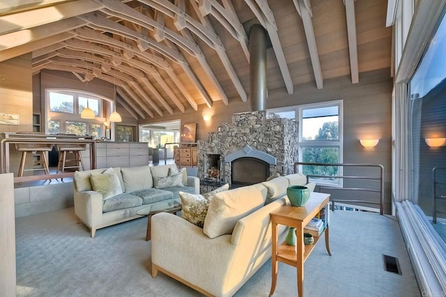 living room featuring high vaulted ceiling, light colored carpet, a fireplace, and beam ceiling