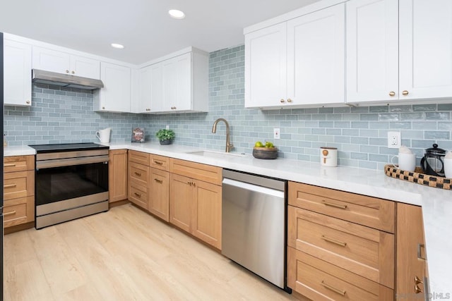 kitchen with sink, white cabinets, stainless steel appliances, and tasteful backsplash