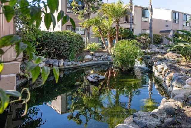 view of community with a garden pond