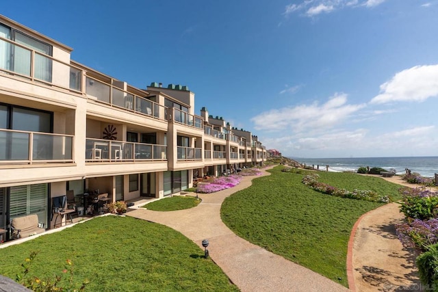 view of property's community featuring a water view and a yard