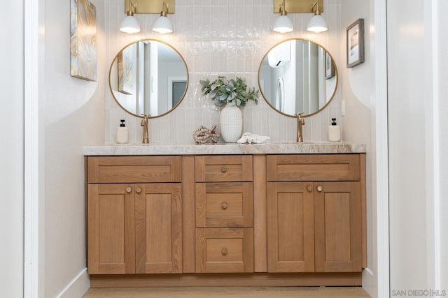 bathroom featuring decorative backsplash and vanity