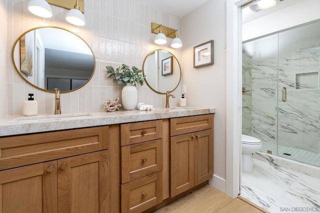 bathroom featuring a shower with shower door, vanity, toilet, and hardwood / wood-style flooring