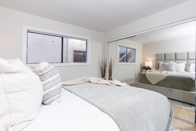 bedroom with light wood-type flooring and a closet