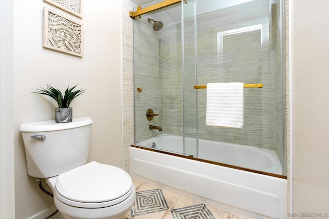 bathroom featuring toilet, tile patterned flooring, and shower / bath combination with glass door