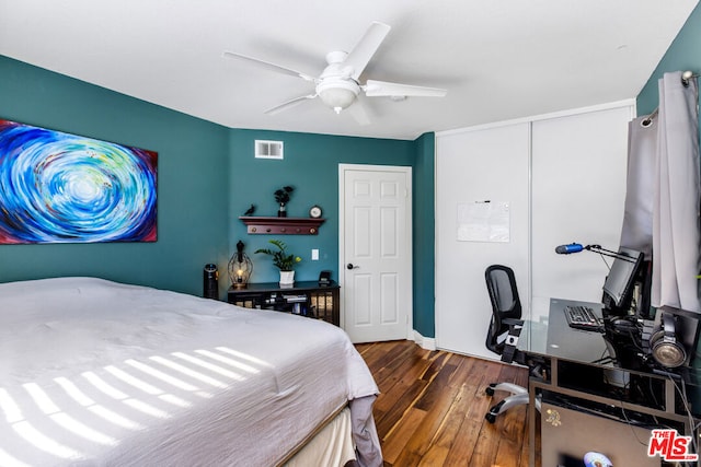 bedroom with ceiling fan and dark hardwood / wood-style flooring