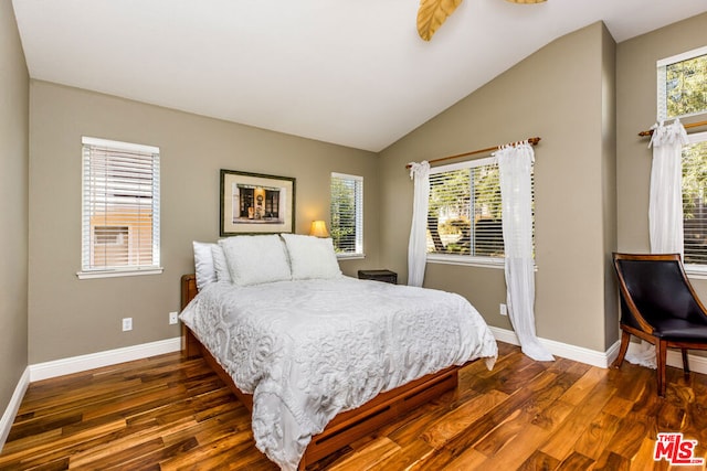 bedroom with dark wood-type flooring and lofted ceiling