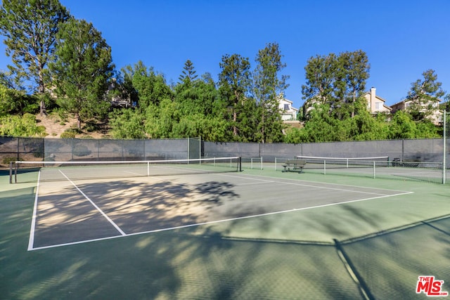 view of sport court with basketball hoop