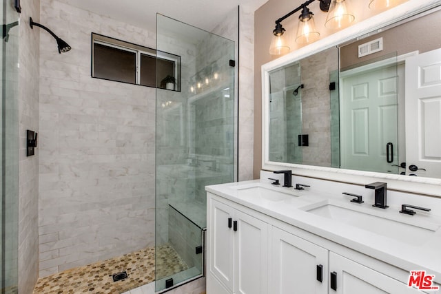 bathroom featuring vanity and a shower with door