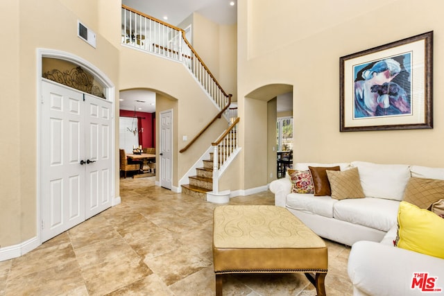 living room with a towering ceiling