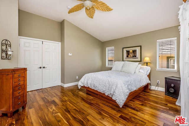 bedroom featuring ceiling fan, a closet, dark hardwood / wood-style floors, and vaulted ceiling