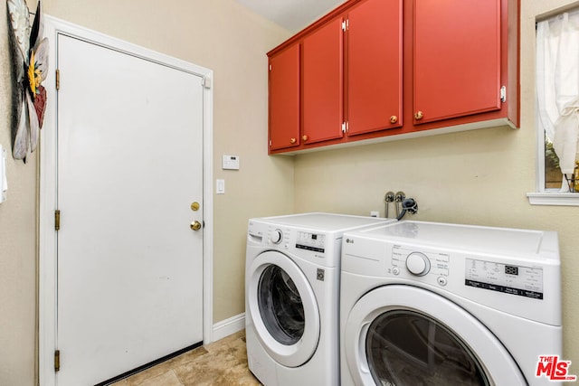 laundry area featuring cabinets and washer and clothes dryer