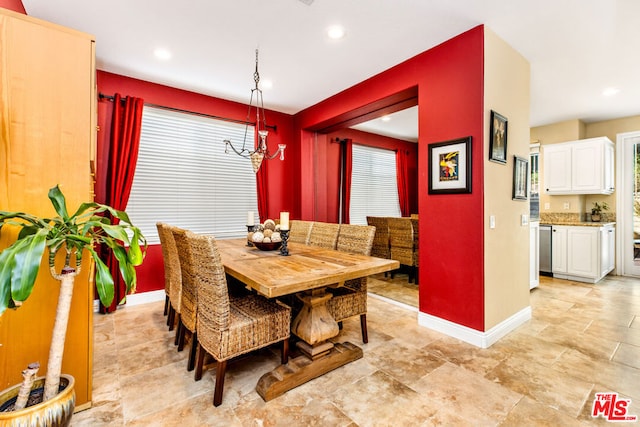 dining space featuring a healthy amount of sunlight and an inviting chandelier