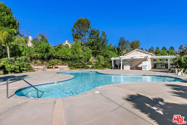 view of pool featuring a pergola and a patio area