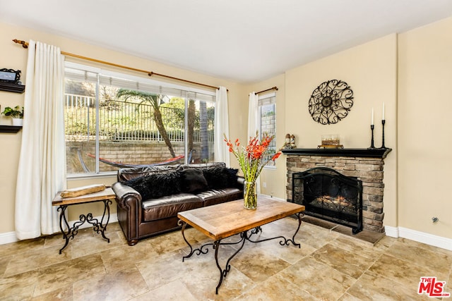 living room with a stone fireplace