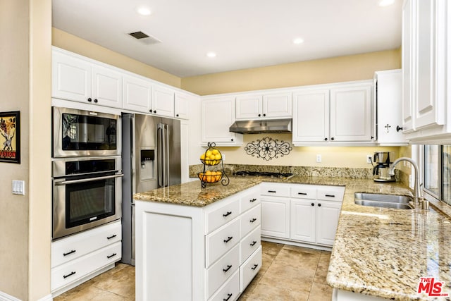 kitchen with light stone countertops, sink, white cabinetry, and stainless steel appliances