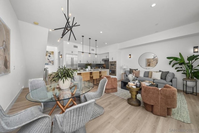 dining space featuring a chandelier and light hardwood / wood-style flooring