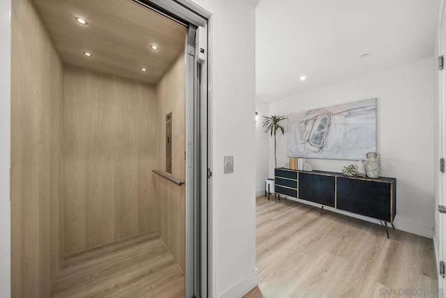 bathroom featuring wood-type flooring and elevator