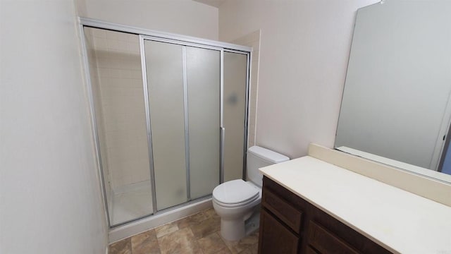 bathroom with toilet, walk in shower, and vanity