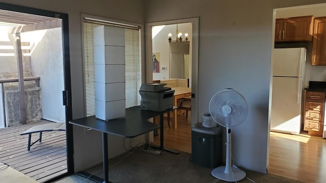 office area with an inviting chandelier and wood-type flooring