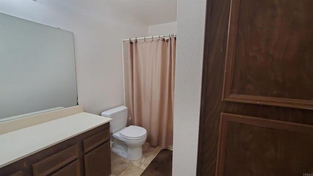 bathroom featuring toilet and vanity