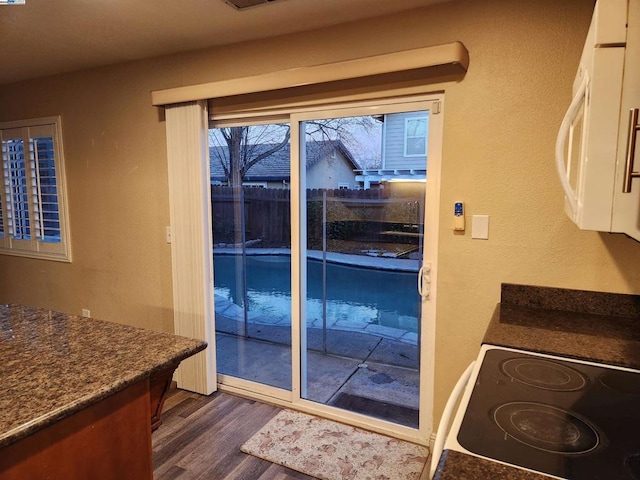 doorway to outside with dark hardwood / wood-style floors