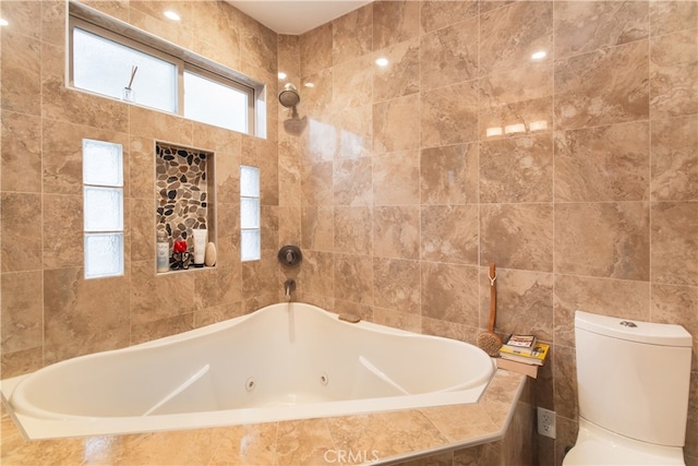 bathroom with toilet, tile walls, and a relaxing tiled tub