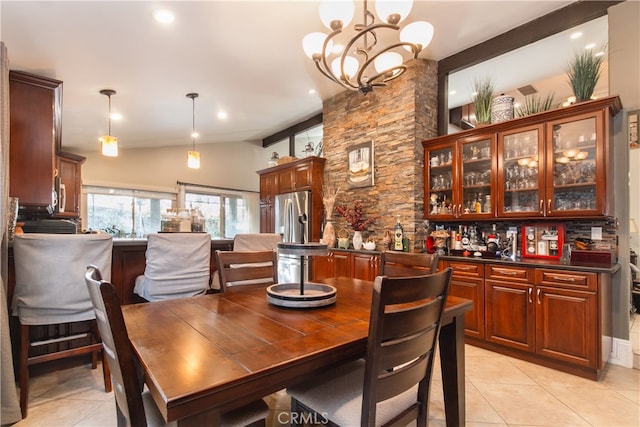 tiled dining space with lofted ceiling and a chandelier