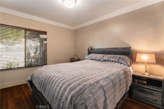 bedroom featuring multiple windows, dark hardwood / wood-style flooring, and crown molding