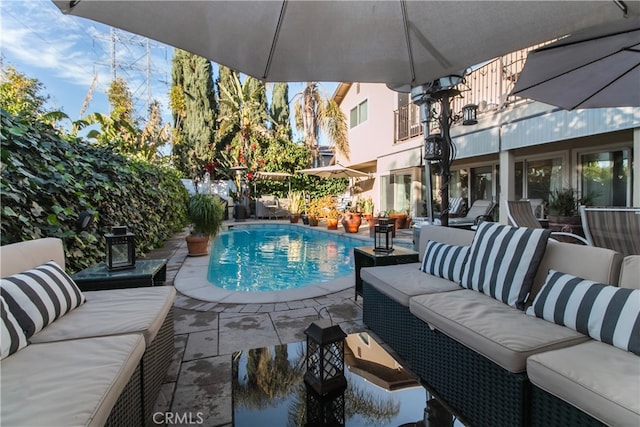 view of pool with outdoor lounge area and a patio