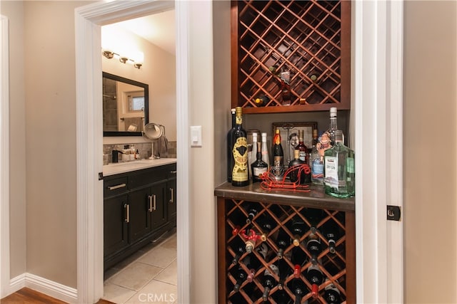 wine area featuring light tile patterned floors and indoor bar