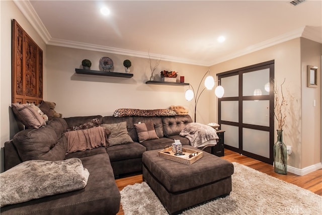 living room featuring crown molding and light hardwood / wood-style floors