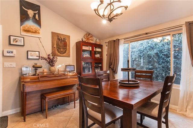 tiled dining space featuring lofted ceiling and a notable chandelier