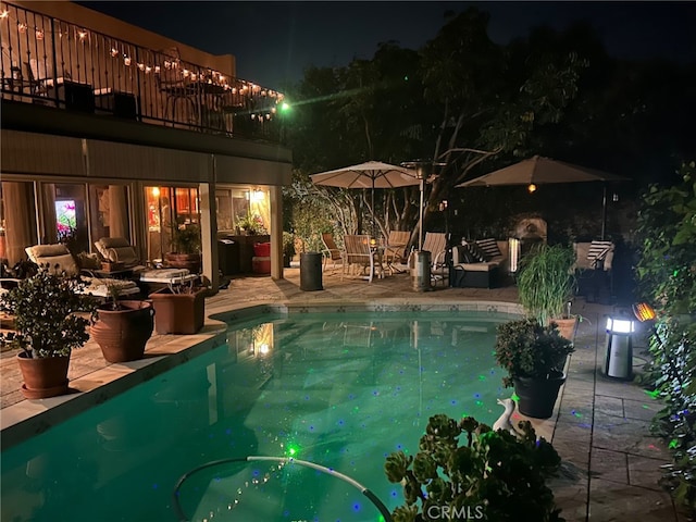 pool at night with a patio