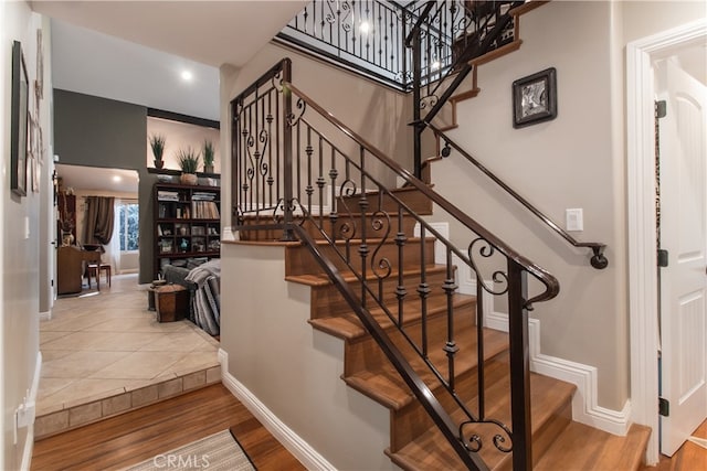 staircase with wood-type flooring