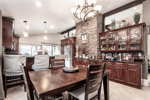 dining space with an inviting chandelier, lofted ceiling with beams, and light tile patterned floors