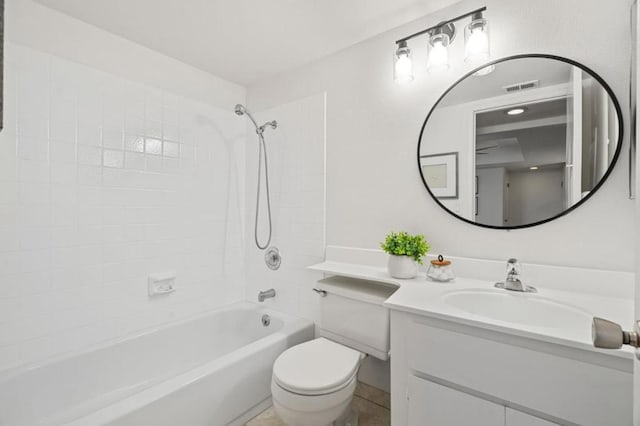 full bathroom with tiled shower / bath combo, vanity, and toilet