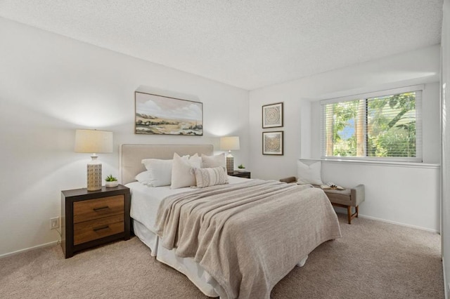 bedroom with light carpet and a textured ceiling