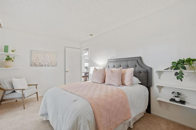 carpeted bedroom featuring a textured ceiling