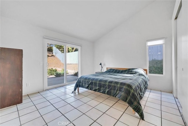 bedroom featuring vaulted ceiling, access to outside, and light tile patterned flooring