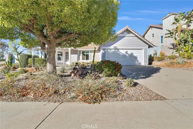 view of property hidden behind natural elements featuring a garage