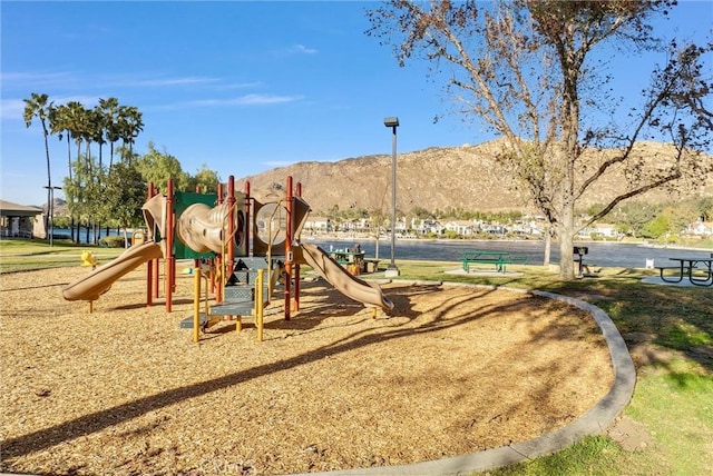 view of jungle gym with a mountain view