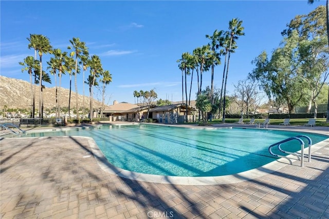 view of swimming pool with a mountain view and a patio