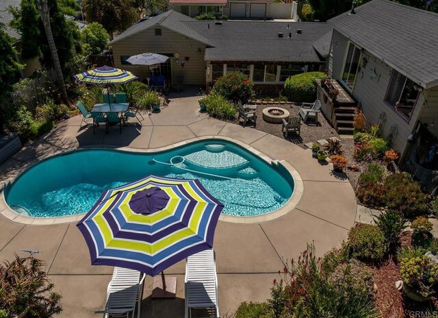 view of swimming pool with a patio area and an outdoor fire pit