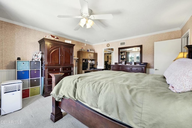 carpeted bedroom featuring ceiling fan and crown molding