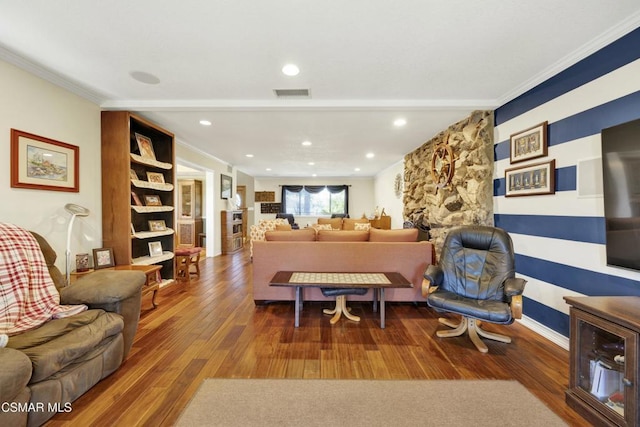 living room featuring dark wood-type flooring and ornamental molding