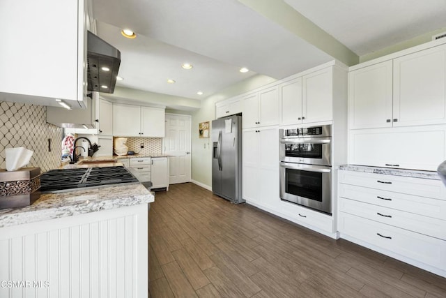 kitchen featuring white cabinetry, dark hardwood / wood-style flooring, stainless steel appliances, tasteful backsplash, and sink